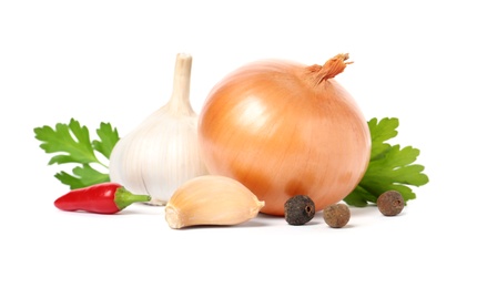 Photo of Garlic, onion, parsley, allspice and chili peppers on white background