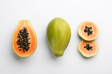 Photo of Fresh ripe papaya fruits on white background, flat lay