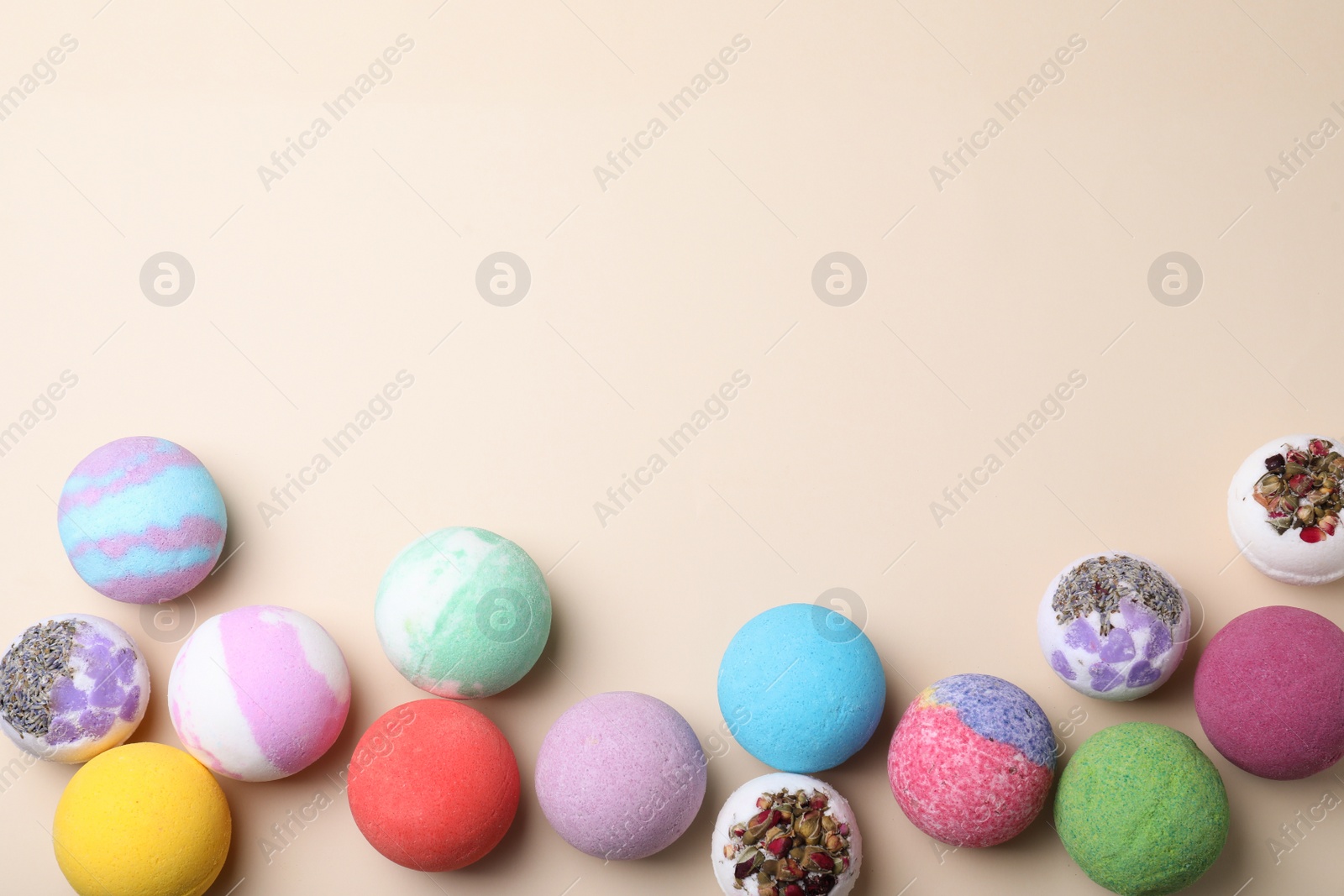 Photo of Colorful bath bombs on light background, flat lay. Space for text