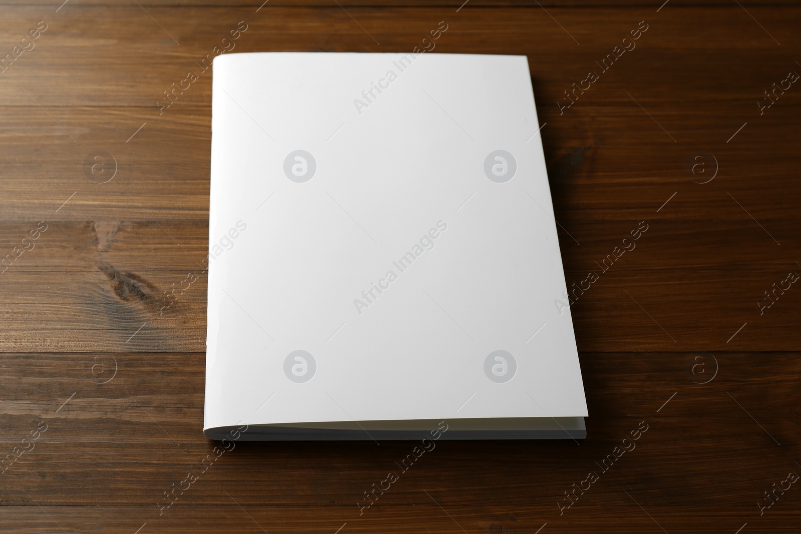 Photo of Blank paper brochure on wooden table. Mockup for design