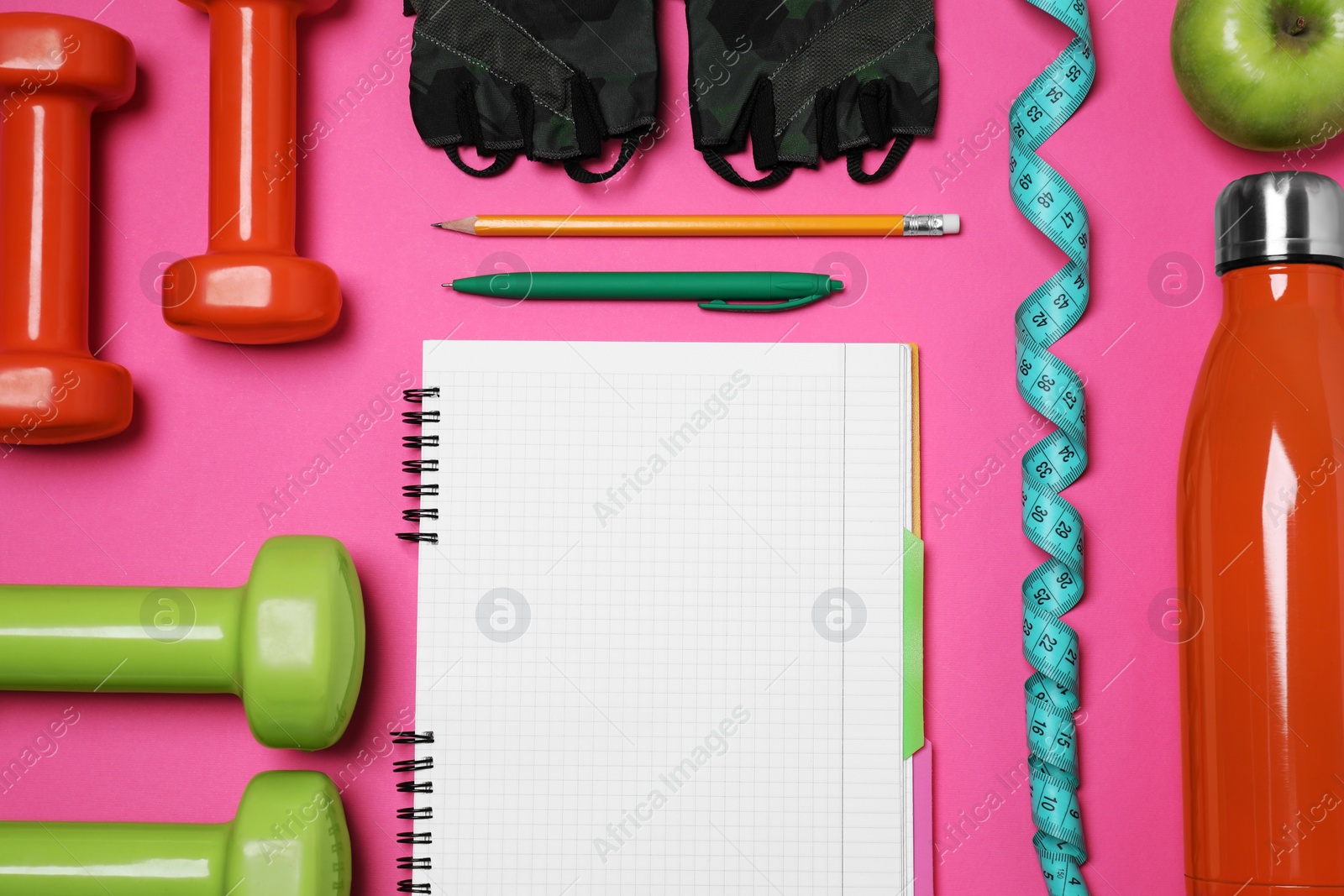 Photo of Notebook, pen and sports equipment on pink background, flat lay. Personal training