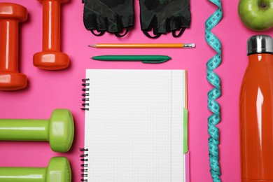 Photo of Notebook, pen and sports equipment on pink background, flat lay. Personal training