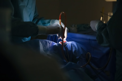 Professional doctors performing operation in surgery room, closeup