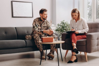 Photo of Psychologist working with military officer in office