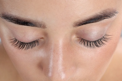 Photo of Young woman with beautiful eyelashes, closeup view