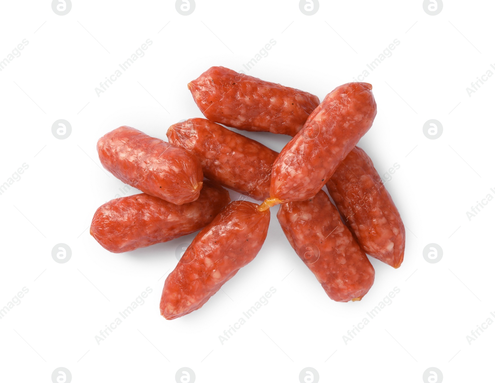 Photo of Many thin dry smoked sausages isolated on white, top view