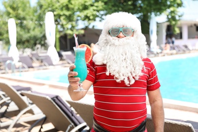 Authentic Santa Claus with cocktail at resort