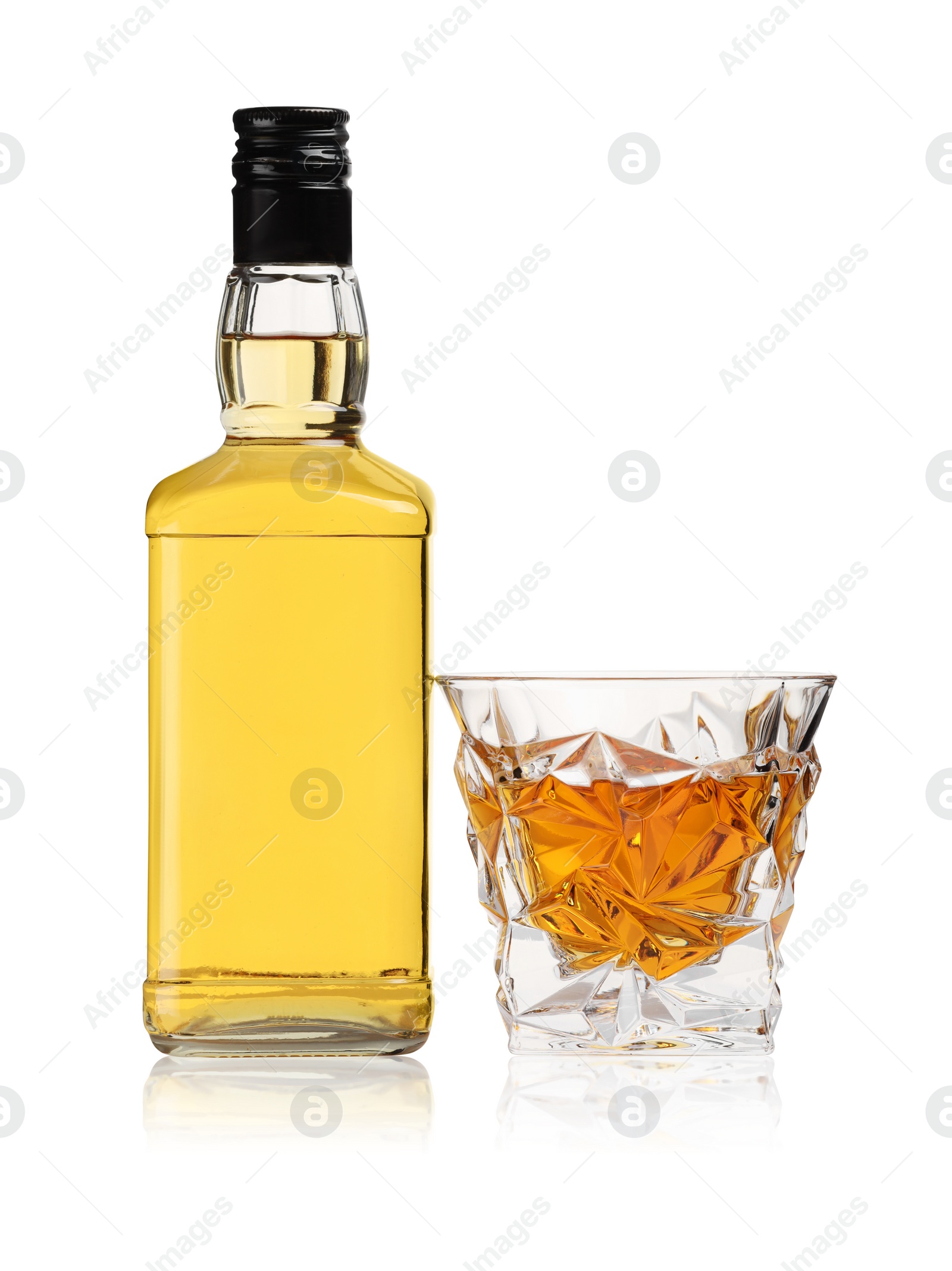 Photo of Glass and bottle of whiskey isolated on white