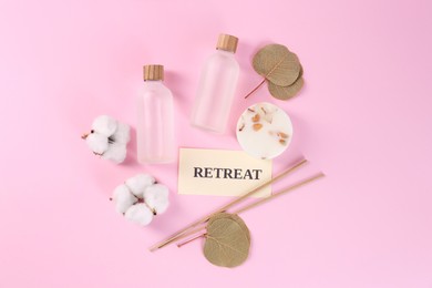 Photo of Retreat concept. Flat lay composition with card, bottles of cosmetic products and cotton flowers on pink background
