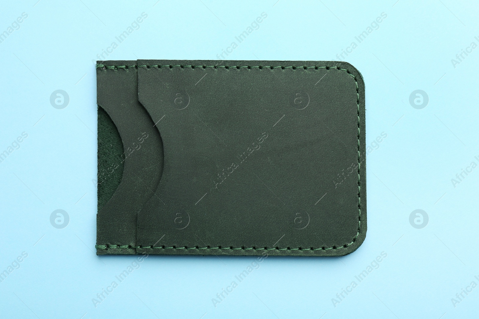 Photo of Empty leather card holder on light blue background, top view