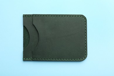 Photo of Empty leather card holder on light blue background, top view