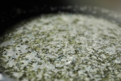 Photo of Melting butter in frying pan, closeup view