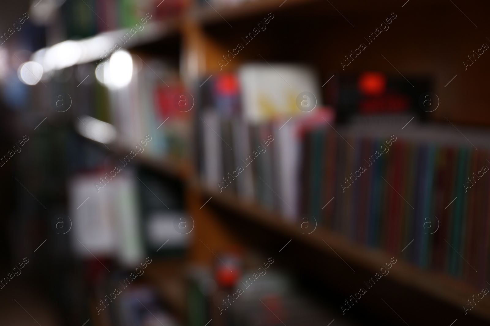 Photo of Blurred view of different books on shelves in library