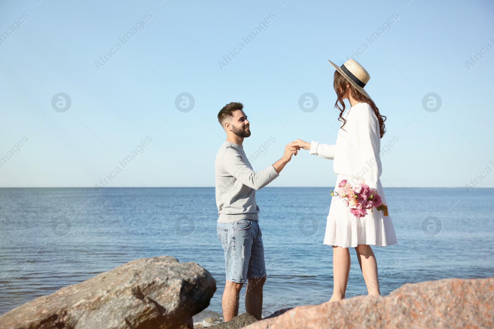 Photo of Happy young couple on beach near sea. Honeymoon trip