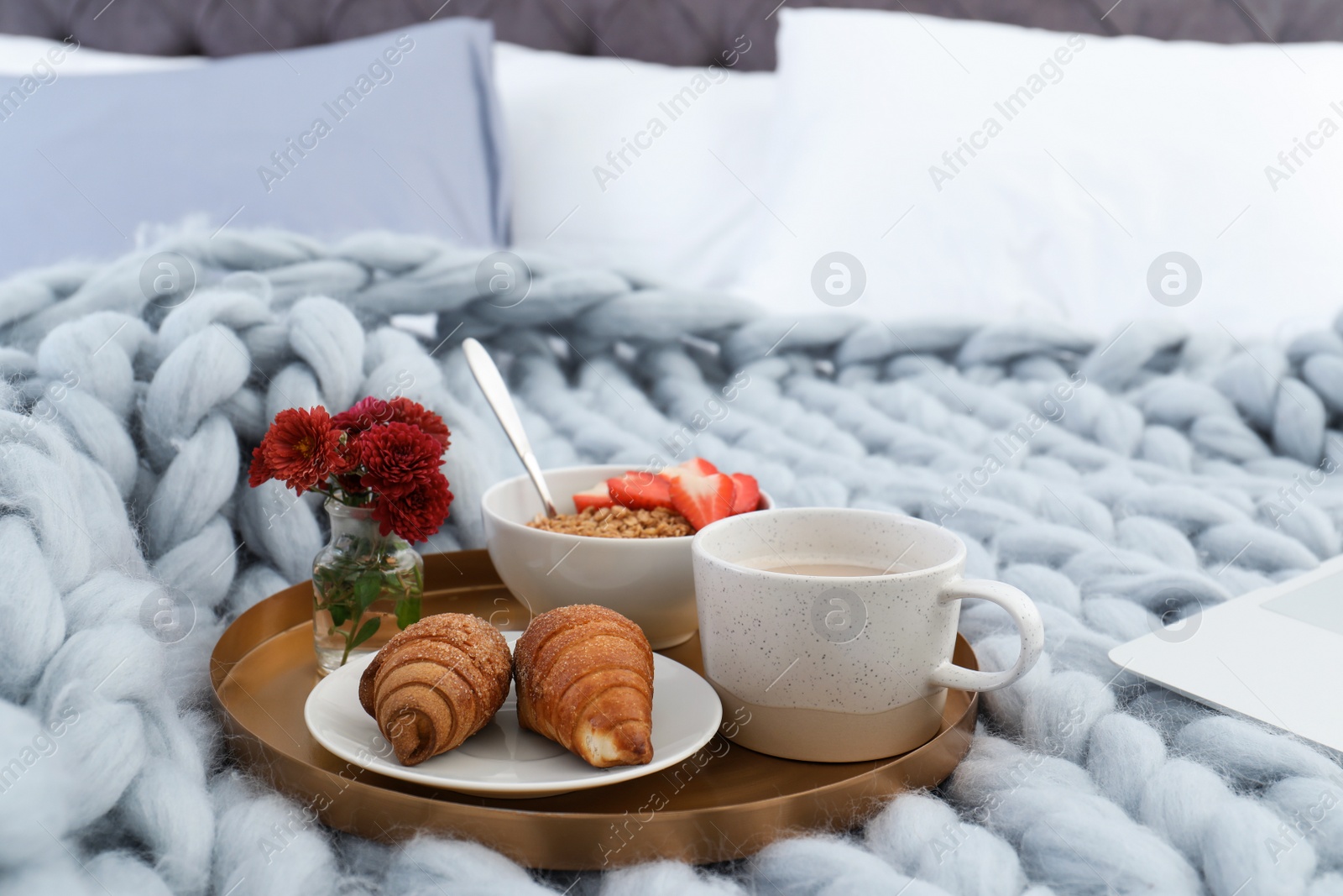 Photo of Tray with breakfast on bed. Interior element