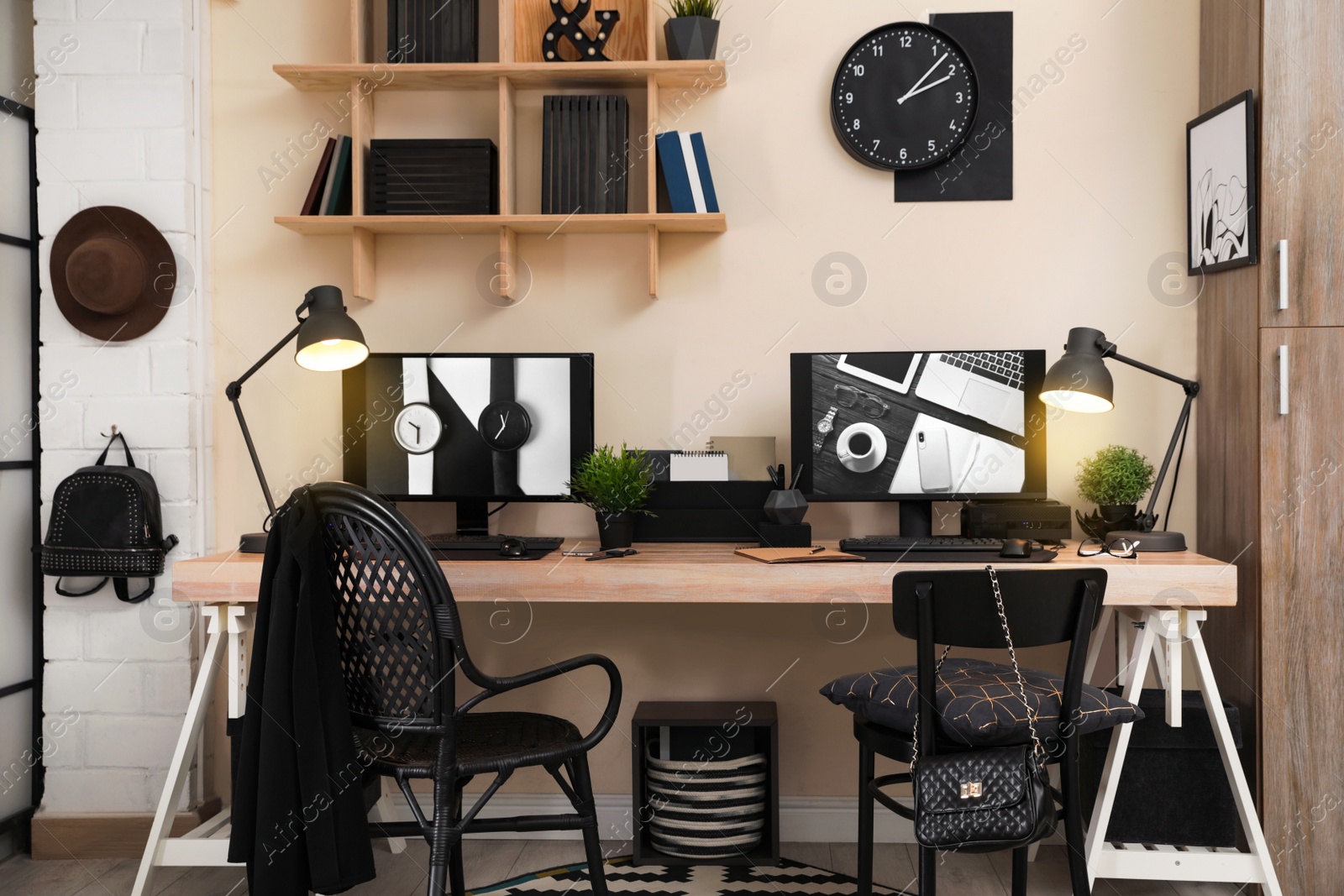 Photo of Stylish workplace interior with computers on table