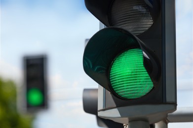 Photo of Traffic light on blurred background, closeup. Space for text