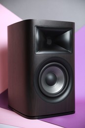 Photo of One wooden sound speaker on color background