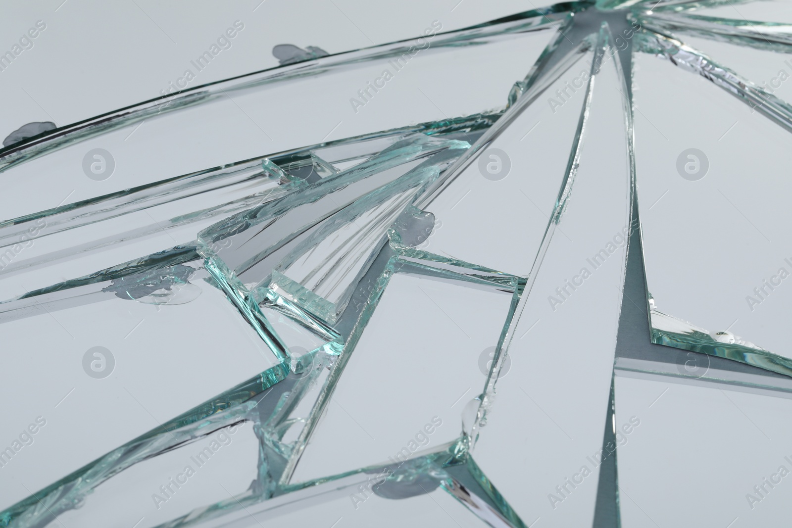 Photo of Broken mirror with many cracks as background, closeup view