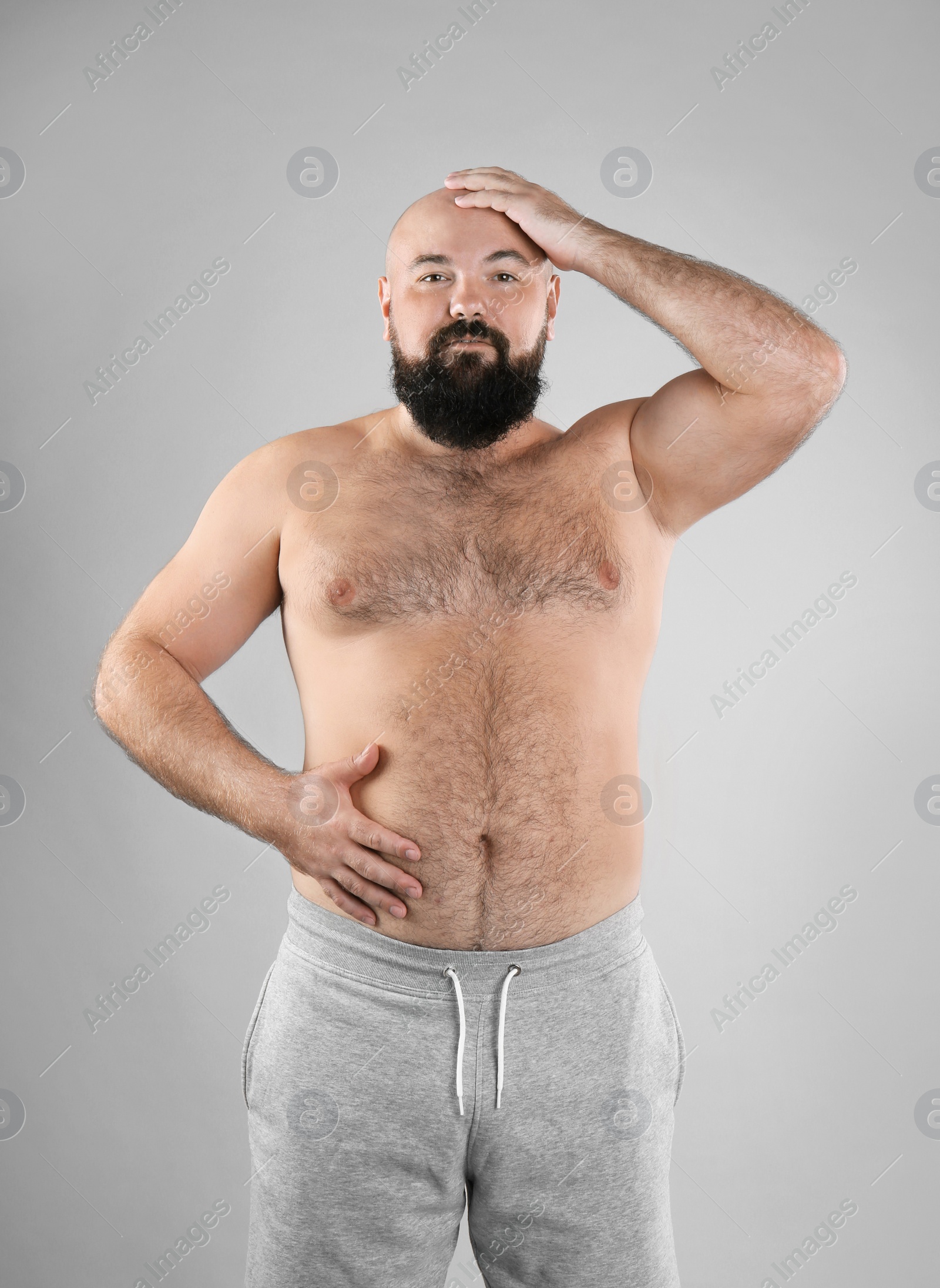 Photo of Fat man on grey background. Weight loss