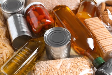 Photo of Different products on white table, closeup. Food donation