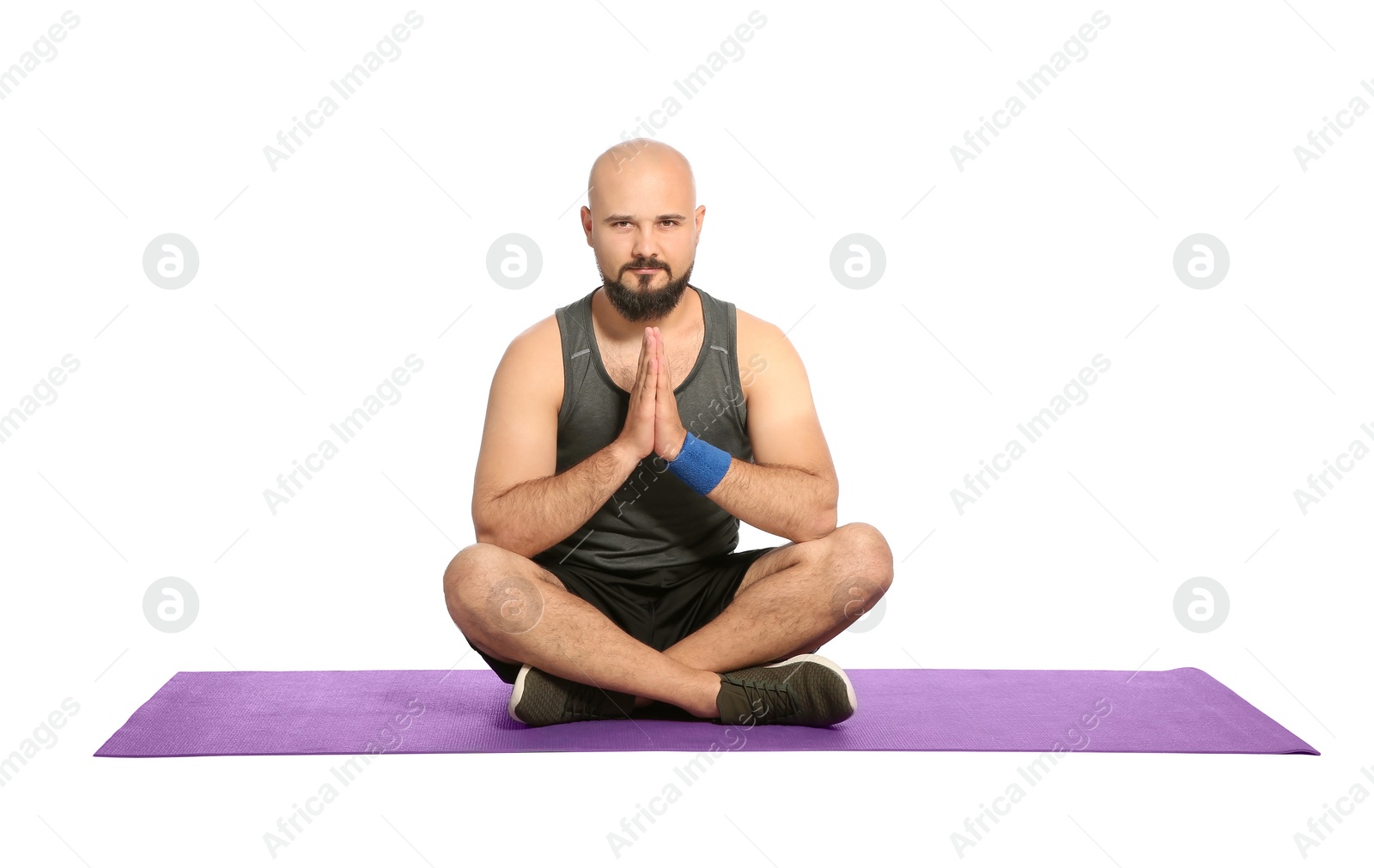 Photo of Overweight man practicing yoga on white background