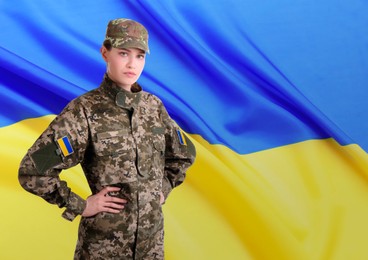 Soldier in military camouflage uniform and Ukrainian flag on background, space for text. Stop war