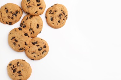 Photo of Many delicious chocolate chip cookies on white background, flat lay. Space for text