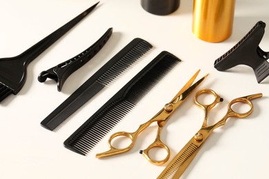 Hairdresser tools. Different scissors and combs on white table