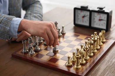 Photo of Man playing chess during tournament at table, closeup