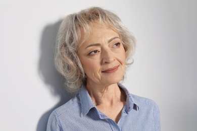 Photo of Portrait of mature woman on grey background