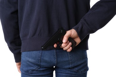 Photo of Man hiding gun behind his back on white background, closeup