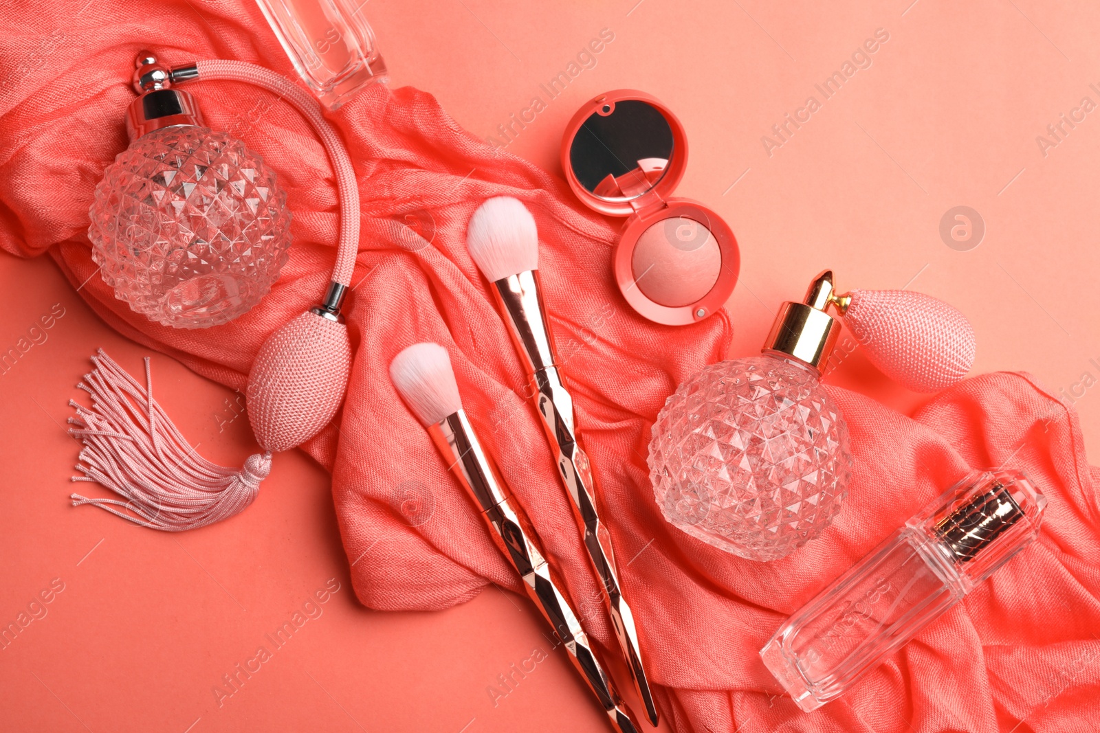 Photo of Flat lay composition with beauty accessories on coral background