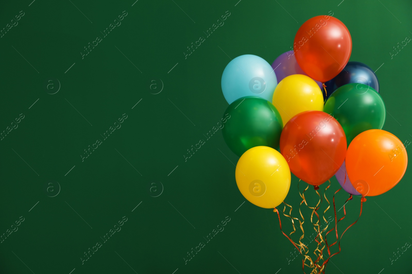 Photo of Bunch of bright balloons on color background, space for text. Celebration time