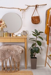 Photo of Modern wooden dressing table with mirror in room