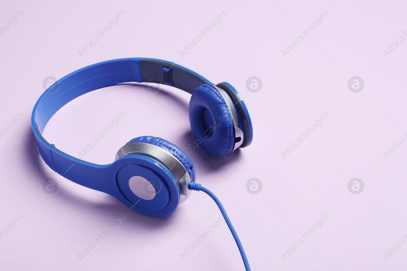 Photo of Stylish headphones on color background. Space for text