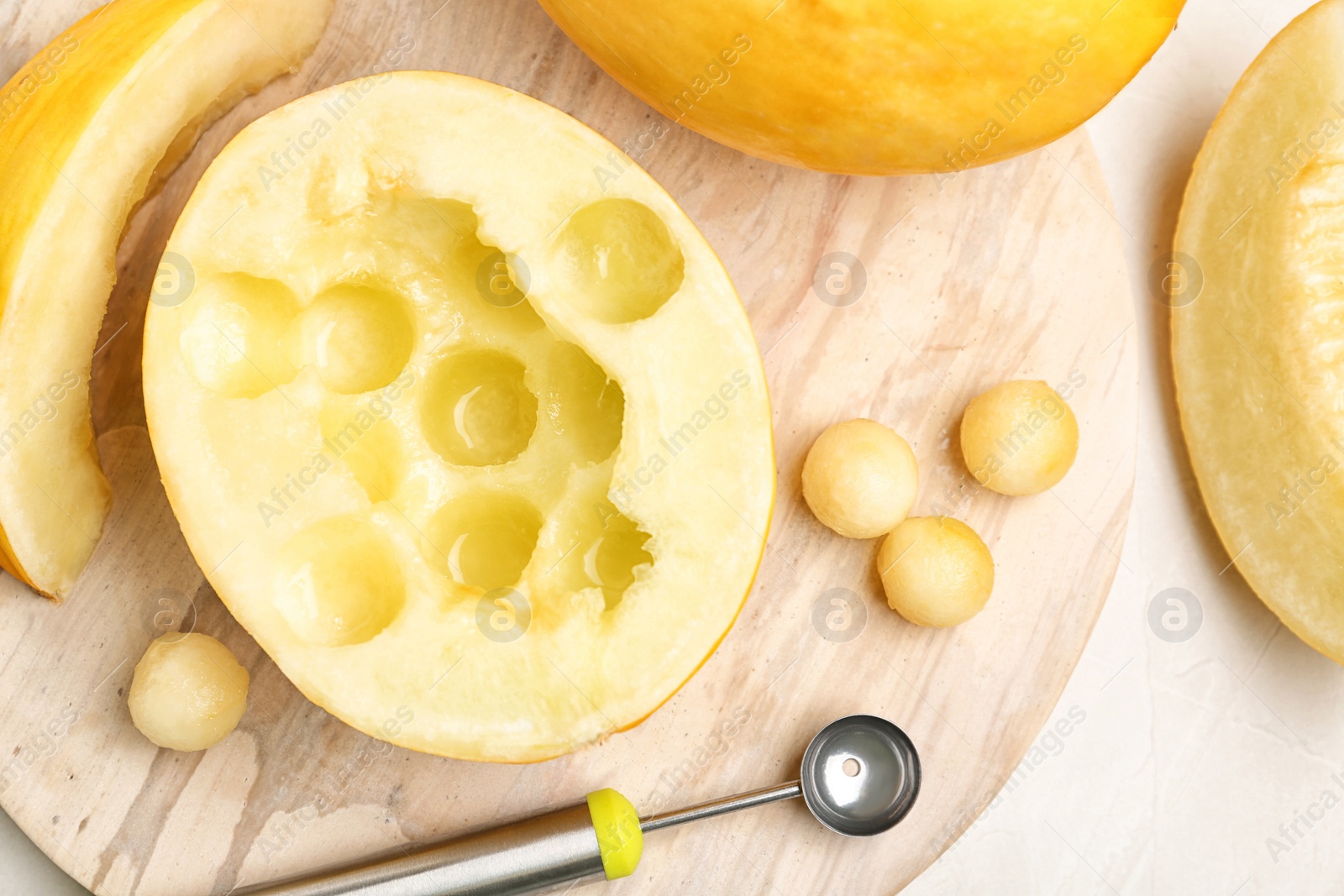 Photo of Flat lay composition with melon balls on light background