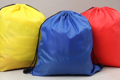 Photo of Three drawstring bags on light table, closeup