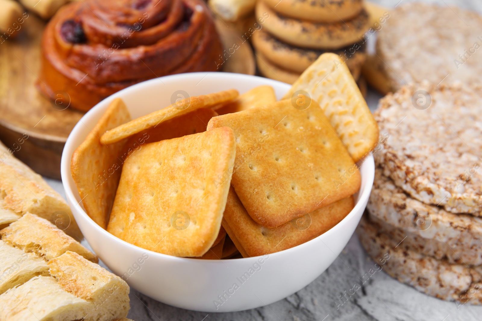 Photo of Different gluten free products on light grey textured table, closeup