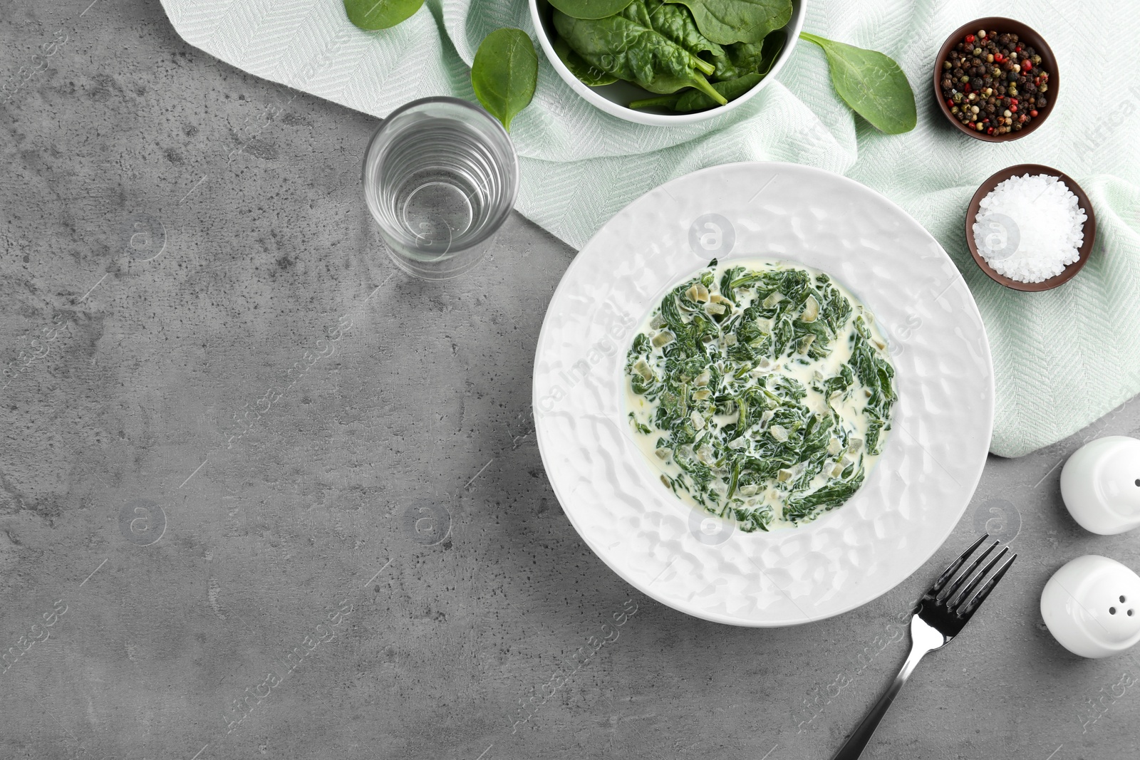 Photo of Tasty spinach dip on grey table, flat lay. Space for text