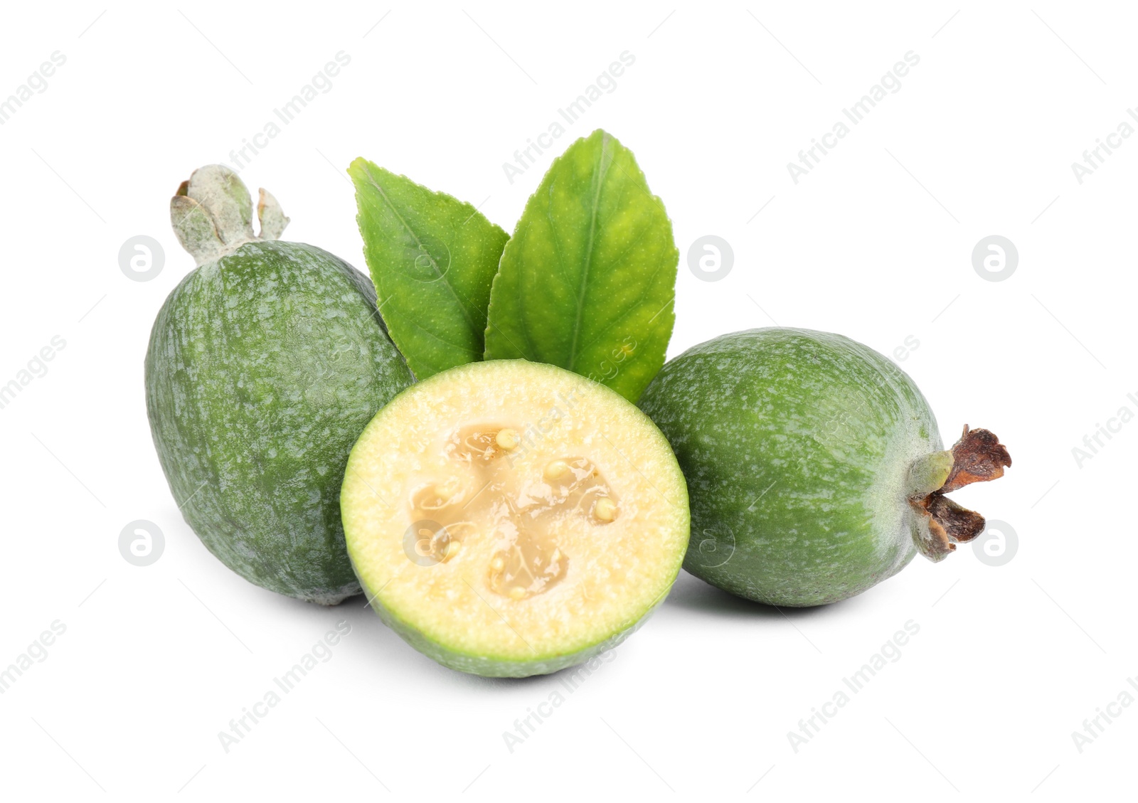 Photo of Cut and whole feijoas with leaves on white background