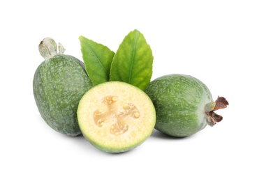 Photo of Cut and whole feijoas with leaves on white background