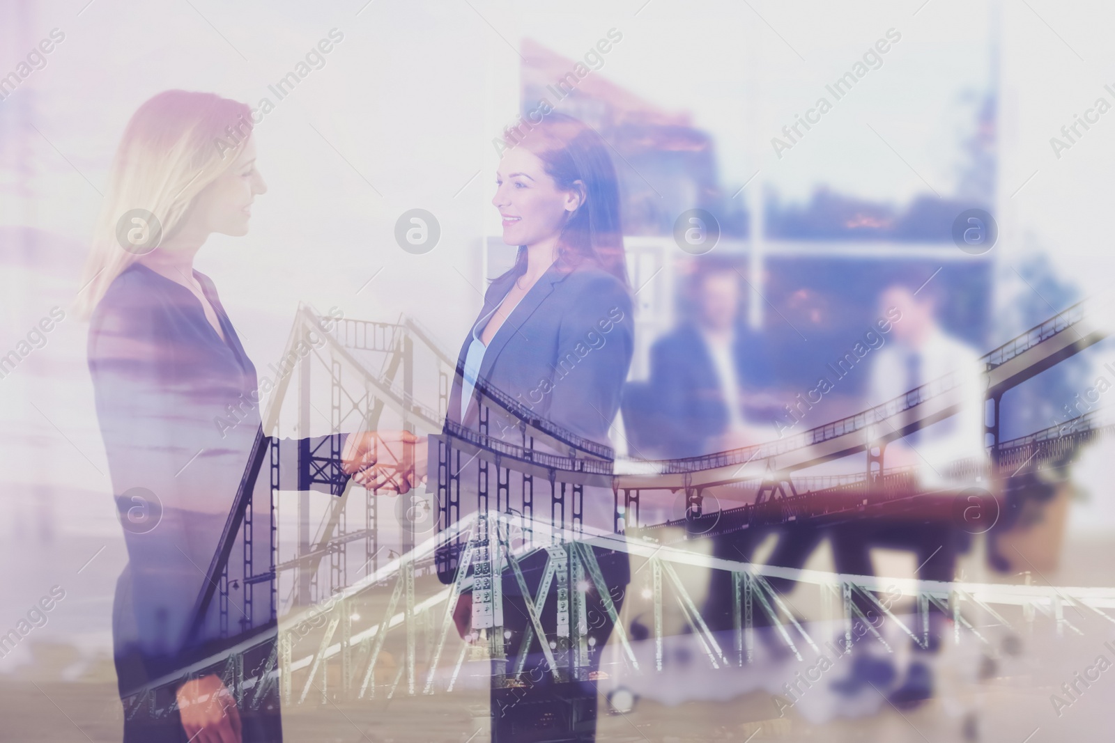 Image of Double exposure of bridge and businesswomen shaking hands in office