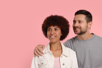 Photo of International dating. Portrait of happy couple on pink background, space for text