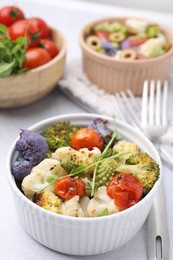 Delicious salad with cauliflower and tomato served on white table