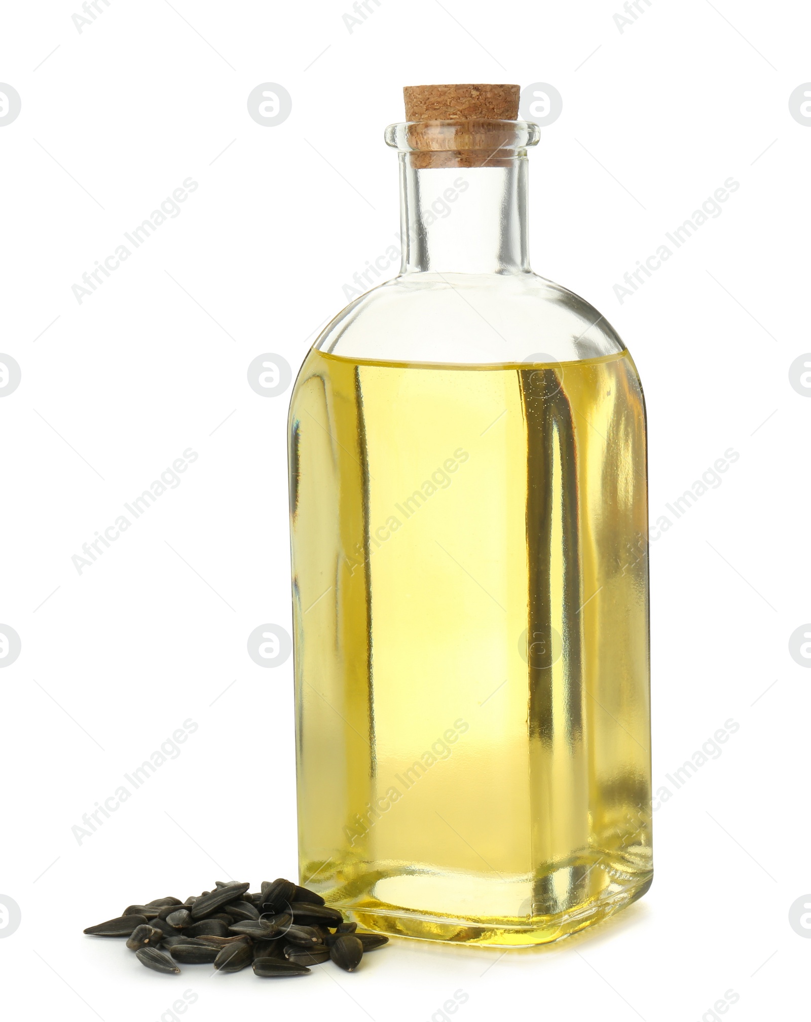 Photo of Vegetable fats. Sunflower oil in glass bottle and seeds isolated on white