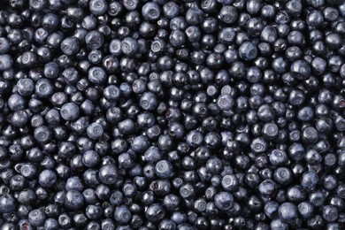 Photo of Many delicious ripe bilberries as background, top view