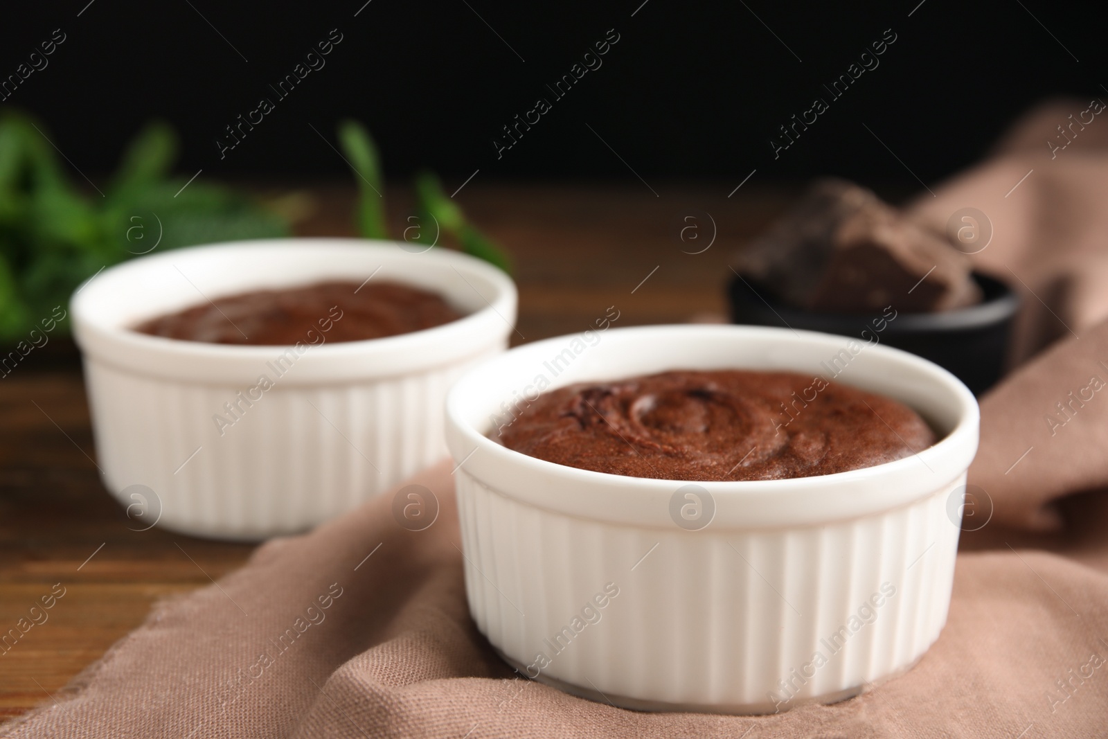 Photo of Delicious fresh chocolate fondant on wooden table, closeup