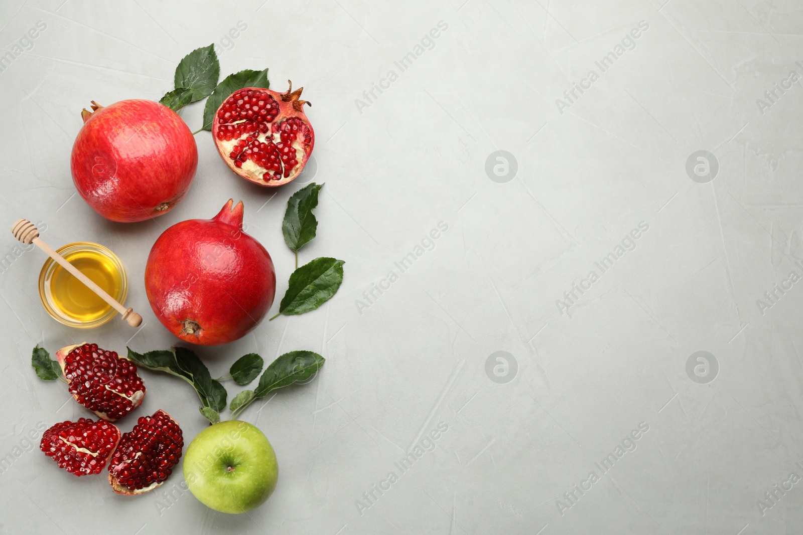 Photo of Flat lay composition with Rosh Hashanah holiday attributes on light grey background. Space for text