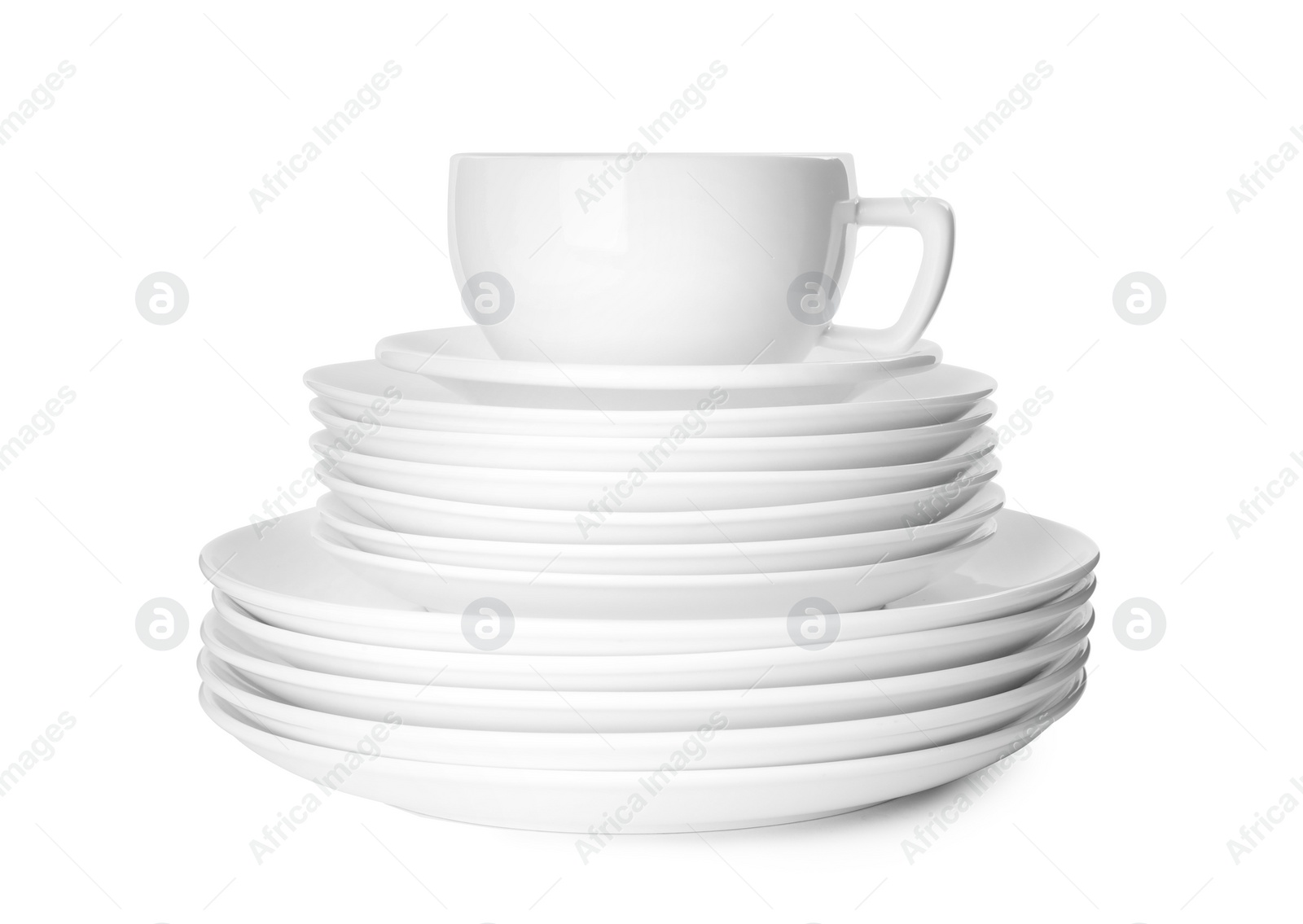 Photo of Stack of clean tableware isolated on white